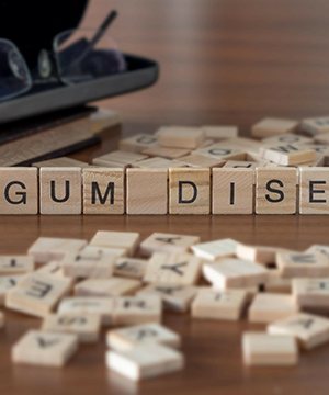 Scabble letters spelling out “gum disease”